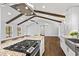 Spacious kitchen boasts an island cooktop, beamed ceilings, and eat in kitchen at 4178 Castle Pines Ct, Tucker, GA 30084