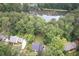Aerial view of the property surrounded by lush trees at 1587 Red Fox Sw Run, Lilburn, GA 30047