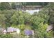 Aerial view of the home and the surrounding lush greenery at 1587 Red Fox Sw Run, Lilburn, GA 30047