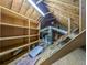Spacious attic featuring ample storage with built-in shelving and easy access for utilities maintenance at 1587 Red Fox Sw Run, Lilburn, GA 30047