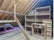 Attic showing bare wood framework, partially-built shelving units, and insulation at 1587 Red Fox Sw Run, Lilburn, GA 30047