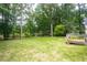 Large, well-maintained backyard with mature trees, view from patio at 1587 Red Fox Sw Run, Lilburn, GA 30047