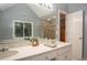 Bright bathroom with double vanity, large mirror, and walk-in shower at 1587 Red Fox Sw Run, Lilburn, GA 30047