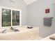 Relaxing bathroom featuring a garden tub and ample natural light from a large window at 1587 Red Fox Sw Run, Lilburn, GA 30047