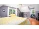 Spacious bedroom featuring hardwood floors, two-tone paint, ceiling fan, and sunny window at 1587 Red Fox Sw Run, Lilburn, GA 30047