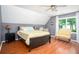 Comfortable bedroom featuring hardwood floors, two-tone paint, and sunny window at 1587 Red Fox Sw Run, Lilburn, GA 30047