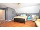 Bedroom with hardwood floors, two-tone paint, ceiling fan, and sitting area at 1587 Red Fox Sw Run, Lilburn, GA 30047