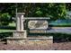Stone base community sign reading 'Rivermist Swim & Tennis' with trees and tennis court background at 1587 Red Fox Sw Run, Lilburn, GA 30047