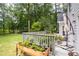 Back deck with raised garden bed and patio furniture overlooking the green backyard at 1587 Red Fox Sw Run, Lilburn, GA 30047