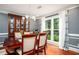 Formal dining room featuring hardwood floors, elegant lighting, and a large window overlooking the garden at 1587 Red Fox Sw Run, Lilburn, GA 30047