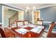 Elegant dining room with hardwood floors, classic wainscoting, and a stylish chandelier at 1587 Red Fox Sw Run, Lilburn, GA 30047