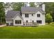 Rear view of the home showcasing the backyard and deck at 1587 Red Fox Sw Run, Lilburn, GA 30047