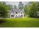 Rear exterior view of the home highlighting the deck and lush yard at 1587 Red Fox Sw Run, Lilburn, GA 30047