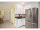 Kitchen features white cabinets, stainless steel appliances, and granite countertops at 1587 Red Fox Sw Run, Lilburn, GA 30047