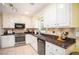Kitchen featuring granite countertops, stainless steel oven, and tile flooring at 1587 Red Fox Sw Run, Lilburn, GA 30047