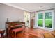 Cozy space with a piano, hardwood floors, and bright window view at 1587 Red Fox Sw Run, Lilburn, GA 30047