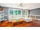 Inviting living room featuring hardwood floors, a comfortable sectional sofa, and large windows at 1587 Red Fox Sw Run, Lilburn, GA 30047