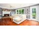 Cozy living room with hardwood floors, brick fireplace, and large windows offering natural light at 1587 Red Fox Sw Run, Lilburn, GA 30047