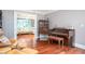 Open living room with piano, hardwood floors, and comfortable seating at 1587 Red Fox Sw Run, Lilburn, GA 30047