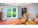 Living room with hardwood floors, large window, and comfortable seating at 1587 Red Fox Sw Run, Lilburn, GA 30047