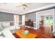 Spacious living room with hardwood floors, gray walls, a tan sectional and a view to the front of the house at 1587 Red Fox Sw Run, Lilburn, GA 30047