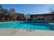Outdoor swimming pool with clear blue water, surrounded by trees and a covered seating area at 1587 Red Fox Sw Run, Lilburn, GA 30047