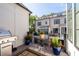Private balcony area with black metal railings, pots with flowers, and a grill at 18 Peachtree Ne Ave # 5, Atlanta, GA 30305