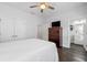 Cozy bedroom with wood floors, ceiling fan, closet, dresser and a view of the bathroom at 18 Peachtree Ne Ave # 5, Atlanta, GA 30305