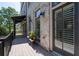 Outdoor deck with metal railings, small tables with flowers, and exterior brick wall at 18 Peachtree Ne Ave # 5, Atlanta, GA 30305