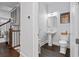 Stylish half bathroom with pedestal sink, toilet, and decorative wall art at 18 Peachtree Ne Ave # 5, Atlanta, GA 30305
