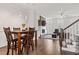 Open-concept living and dining areas with a fireplace, hardwood floors, and a staircase at 18 Peachtree Ne Ave # 5, Atlanta, GA 30305