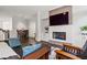 Open-concept living room featuring fireplace, hardwood floors, and comfortable seating at 18 Peachtree Ne Ave # 5, Atlanta, GA 30305