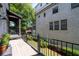Outdoor patio with metal railings, small plants, grass and an exterior brick wall at 18 Peachtree Ne Ave # 5, Atlanta, GA 30305