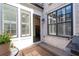 Outdoor patio with grill, table with flowers and views into the home through large windows at 18 Peachtree Ne Ave # 5, Atlanta, GA 30305