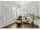 Bright sunroom with hardwood floors, plantation shutters and a comfortable chair at 18 Peachtree Ne Ave # 5, Atlanta, GA 30305