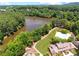 Scenic aerial view of the lake and a large community pool with lush landscaping at 2845 Aquitania Ln, Cumming, GA 30040
