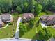 Aerial view of a beautiful home with lush landscaping, a long driveway, and mature trees at 2845 Aquitania Ln, Cumming, GA 30040