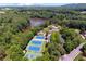 Expansive aerial view showcases community's tennis courts, lake, pool, and green surroundings at 2845 Aquitania Ln, Cumming, GA 30040