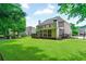 Expansive backyard with a lush lawn, screened porch, and cozy seating area for outdoor enjoyment at 2845 Aquitania Ln, Cumming, GA 30040
