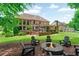 Beautiful backyard with a stone fire pit surrounded by Adirondack chairs, perfect for outdoor gatherings at 2845 Aquitania Ln, Cumming, GA 30040