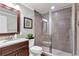 Elegant bathroom with a glass-enclosed shower, mosaic tile accents, and a granite countertop vanity at 2845 Aquitania Ln, Cumming, GA 30040