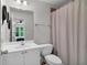 Well-lit bathroom featuring a vanity with white cabinets, a sink, and a shower with a curtain at 2845 Aquitania Ln, Cumming, GA 30040