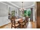 Dining room with hardwood floors, decorative crown molding and access to side porch at 2845 Aquitania Ln, Cumming, GA 30040