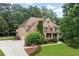 Beautiful home with manicured landscaping, a long driveway, and a lush green lawn at 2845 Aquitania Ln, Cumming, GA 30040