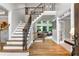 Elegant foyer boasts hardwood floors, staircase with iron spindles, and an abundance of natural light at 2845 Aquitania Ln, Cumming, GA 30040
