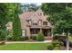 Beautiful two-story brick home featuring a manicured lawn and mature landscaping at 2845 Aquitania Ln, Cumming, GA 30040
