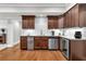 Modern kitchen with dark wood cabinetry, stainless steel appliances, and subway tile backsplash at 2845 Aquitania Ln, Cumming, GA 30040