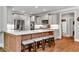 Modern kitchen featuring a large island with seating, stainless steel appliances, and custom cabinets at 2845 Aquitania Ln, Cumming, GA 30040