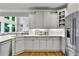 Bright kitchen with white cabinets, stainless steel appliances, and hardwood floors at 2845 Aquitania Ln, Cumming, GA 30040