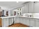 Bright kitchen with white cabinets, stainless steel appliances, hardwood floors, and bay window at 2845 Aquitania Ln, Cumming, GA 30040